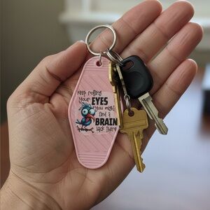 Pink Keychain with Fun Quote “Keep Rolling Your Eyes and You Might Find a Brain”